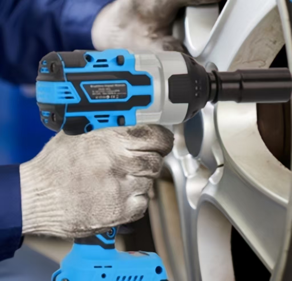 A mechanic repairing a car with an impact wrench