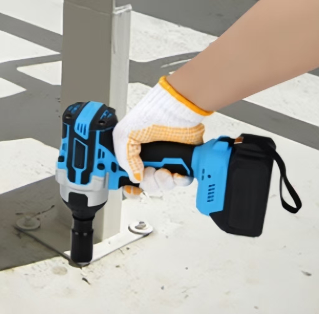 A man is tightening a nut with an impact wrench