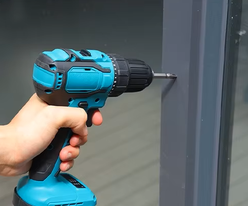 Electric drill drilling metal